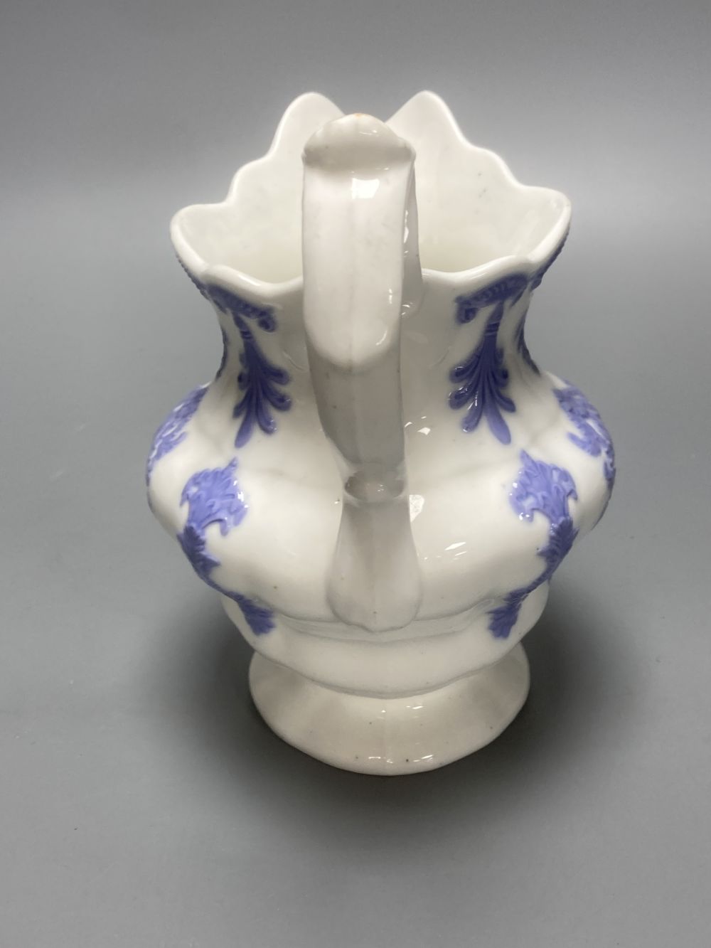 Four early 19th century Staffordshire jugs, each with lilac coloured floral applied panels, one dated 1826, tallest 22cm